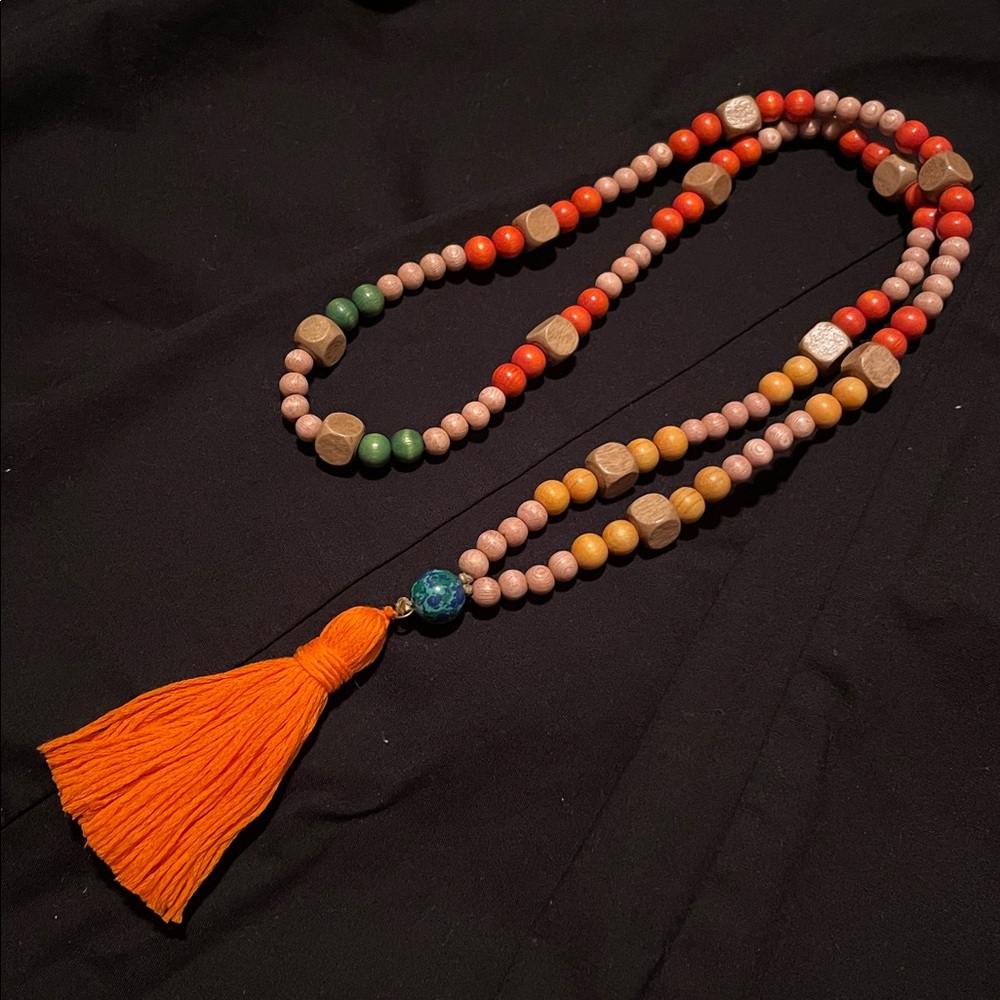 Hand assembled beaded necklace orange tassel